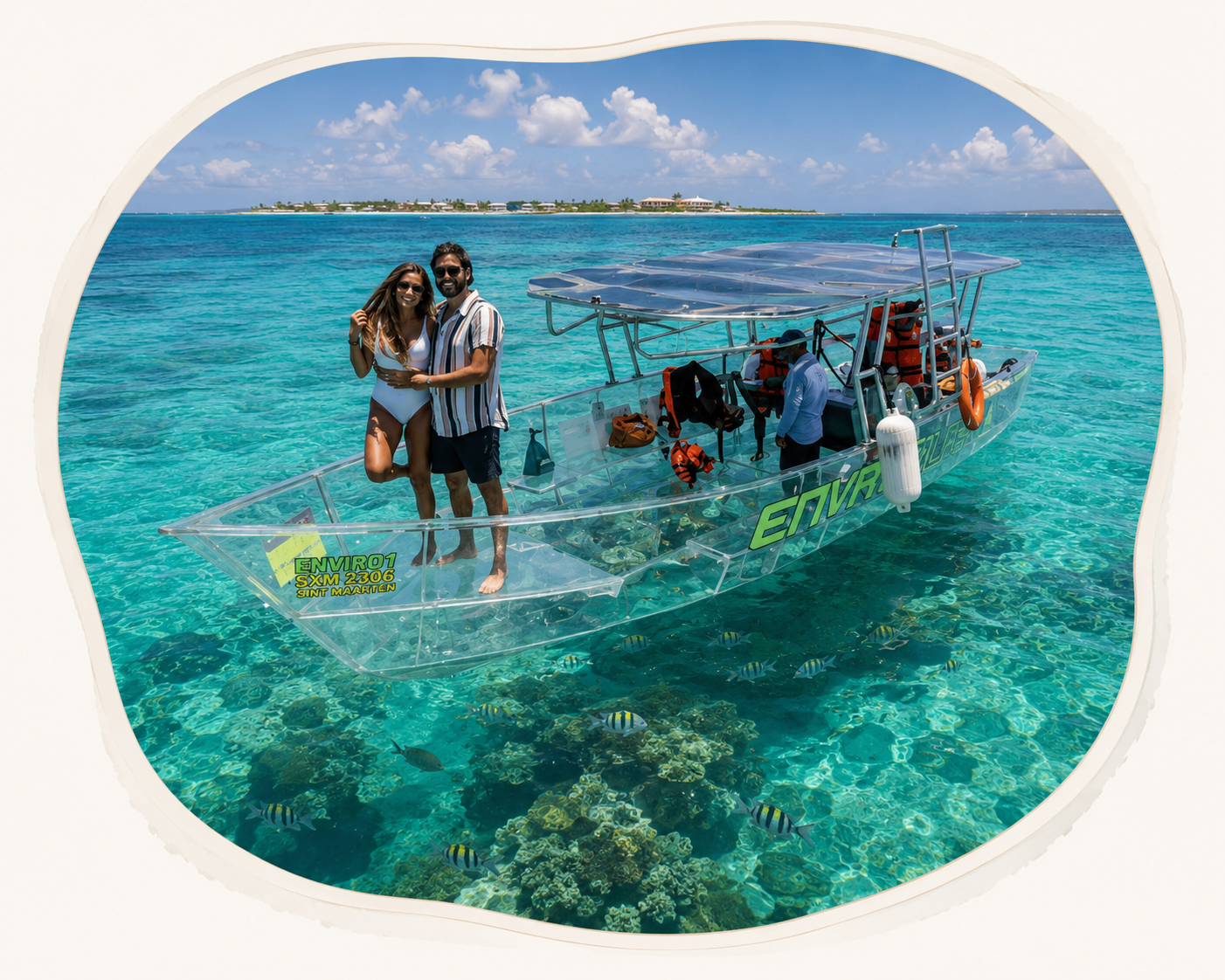 Couple standing on Nevara's clear boat above coral reef in turquoise water.